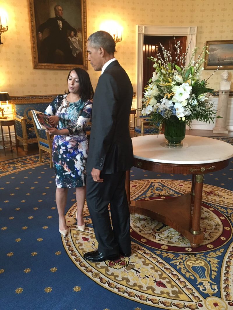 Amanat presenting President Barack Obama a copy of Ms. Marvel Vol. 1 at a reception for Women's History Month. Photo: Valerie Jarrett - https://twitter.com/vj44/status/710234170451034113, Public Domain, https://commons.wikimedia.org/w/index.php?curid=47582179